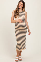 woman wearing a striped beige maternity dress with a ruffled hem and holding her baby bump