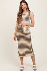 woman wearing a beige and black striped maternity dress and showing her baby bump