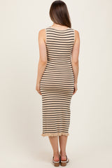 woman wearing a beige and black striped maternity dress with a ruffled hem, viewed from the back