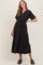 woman wearing a black tiered midi dress with short sleeves and buttons at the neckline