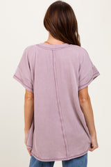 woman wearing a light purple short sleeve oversized top with a textured fabric and a center seam detail