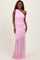 woman wearing a pink one-shoulder evening gown with ruching and a sheer hemline