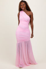 woman wearing a one-shoulder pink ruched evening gown with a flowing skirt