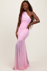 woman wearing a one-shoulder light pink evening gown with ruched details and a flowing mermaid skirt