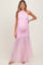 woman wearing a light pink one-shoulder maternity gown with tulle skirt and visible baby bump