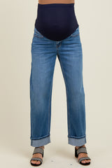 woman wearing a pair of light blue maternity jeans with a dark blue over-the-bump waistband and cuffed hems