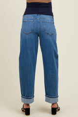 woman wearing a pair of light wash maternity jeans with rolled cuffs, viewed from the back