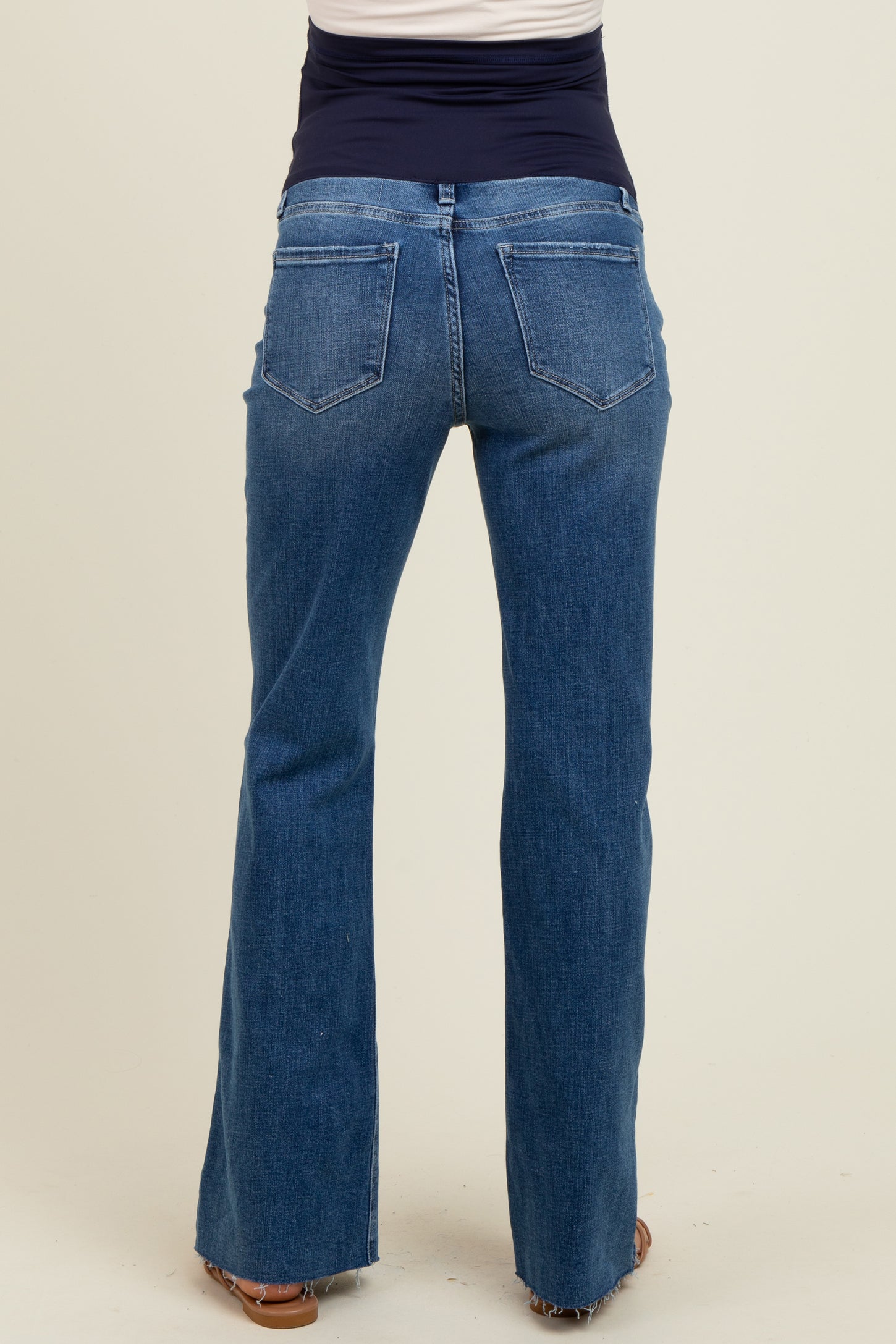 maternity wear blue flared jeans with a stretchy waistband, shown from the back