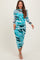 woman wearing a blue camouflage print maternity dress with long sleeves and a fitted silhouette, showcasing her baby bump