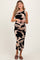 woman wearing a black and beige sleeveless maternity dress with an abstract pattern and a visible baby bump