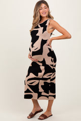 woman wearing a black and beige abstract patterned maternity dress with a visible baby bump
