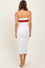 woman wearing a white ribbed midi dress with a red and white striped band at the top, viewed from the back