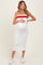 woman wearing a white ribbed maternity midi dress with red and orange stripes and holding her baby bump