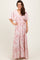 woman wearing a pink floral maxi dress with short sleeves and a tiered skirt