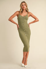 woman wearing a ribbed olive green midi dress with buttons and thin straps