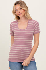 woman wearing a purple and white striped short sleeve top with a scoop neckline and ribbed texture