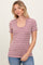 woman wearing a purple and white striped short sleeve top with a scoop neckline and ribbed texture