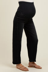 woman wearing black maternity jeans with a supportive waistband and a visible baby bump