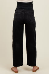 woman wearing black maternity jeans with a relaxed fit, viewed from the back