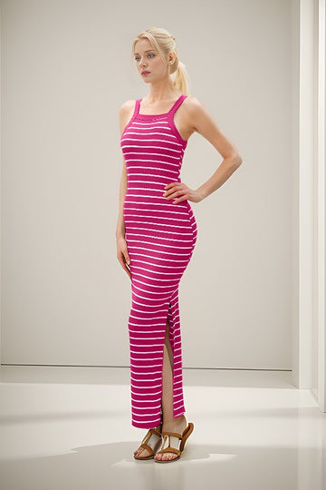 woman wearing a pink and white striped maxi dress with side slits and slide sandals