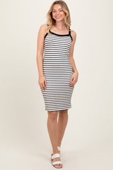 woman wearing a black and white striped tank dress with a fitted silhouette and shoulder straps
