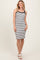 woman wearing a black and white striped tank dress with a fitted silhouette and shoulder straps