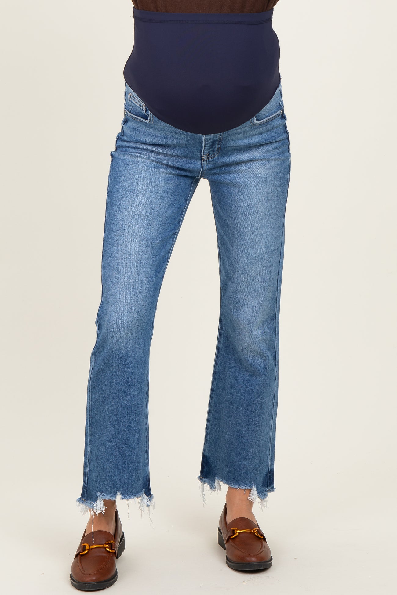 woman wearing a dark blue maternity belly support jeans with frayed hem and light blue wash