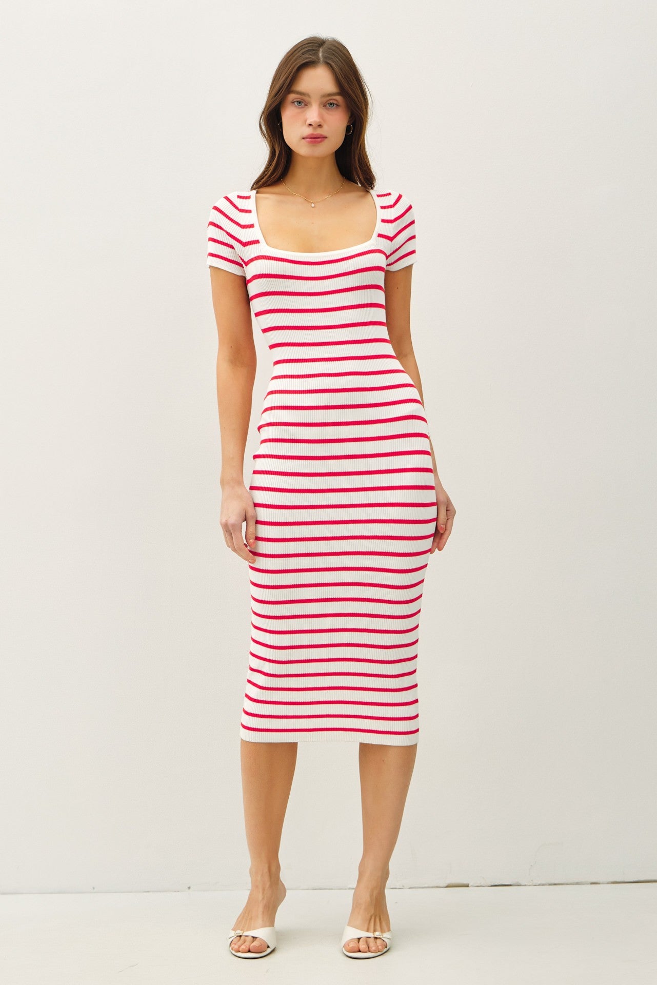 woman wearing a white and red striped midi dress with a scooped neckline and short sleeves