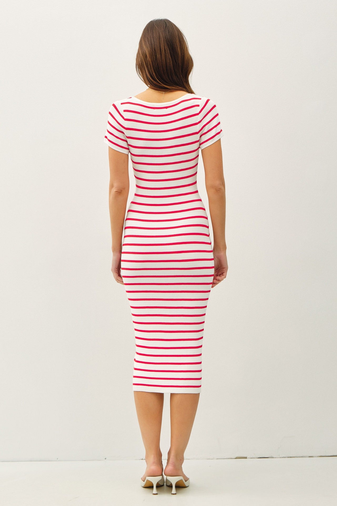 woman wearing a fitted red and white striped midi dress with short sleeves, shown from the back