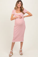 woman wearing a red and white striped maternity dress, showcasing her baby bump, styled with white sandals
