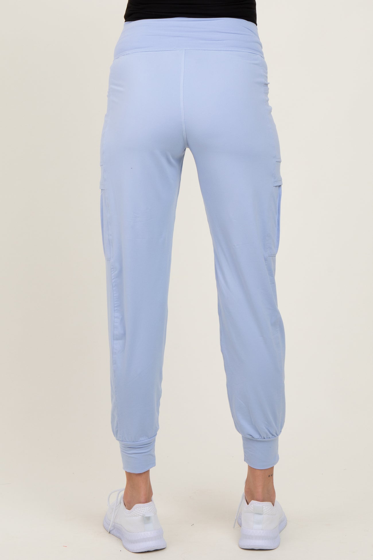 woman wearing light blue maternity jogger pants with side pockets and elasticized cuffs, seen from the back