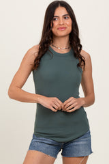woman wearing a dark green sleeveless ribbed tank top and denim shorts