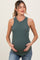 woman wearing a dark green ribbed maternity tank top and holding her baby bump