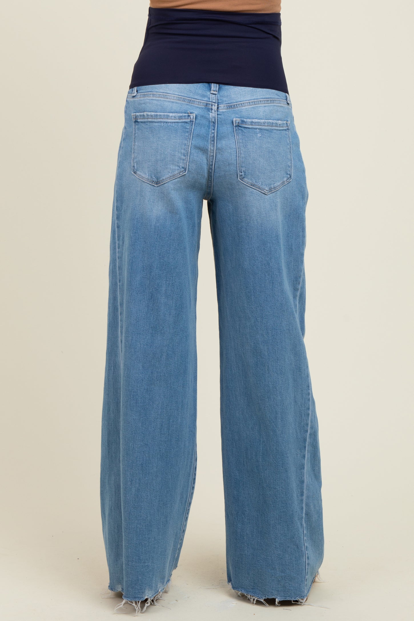 maternity wear light blue wide leg jeans with a high waistband showing a relaxed fit at the back