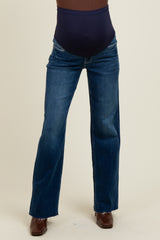 woman wearing a dark blue maternity bootcut jeans with a high waistband for belly support