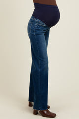 woman wearing dark blue maternity jeans with a supportive over-the-bump waistband and visible baby bump