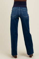 woman wearing dark blue maternity jeans viewed from the back, showing a relaxed fit and wide legs