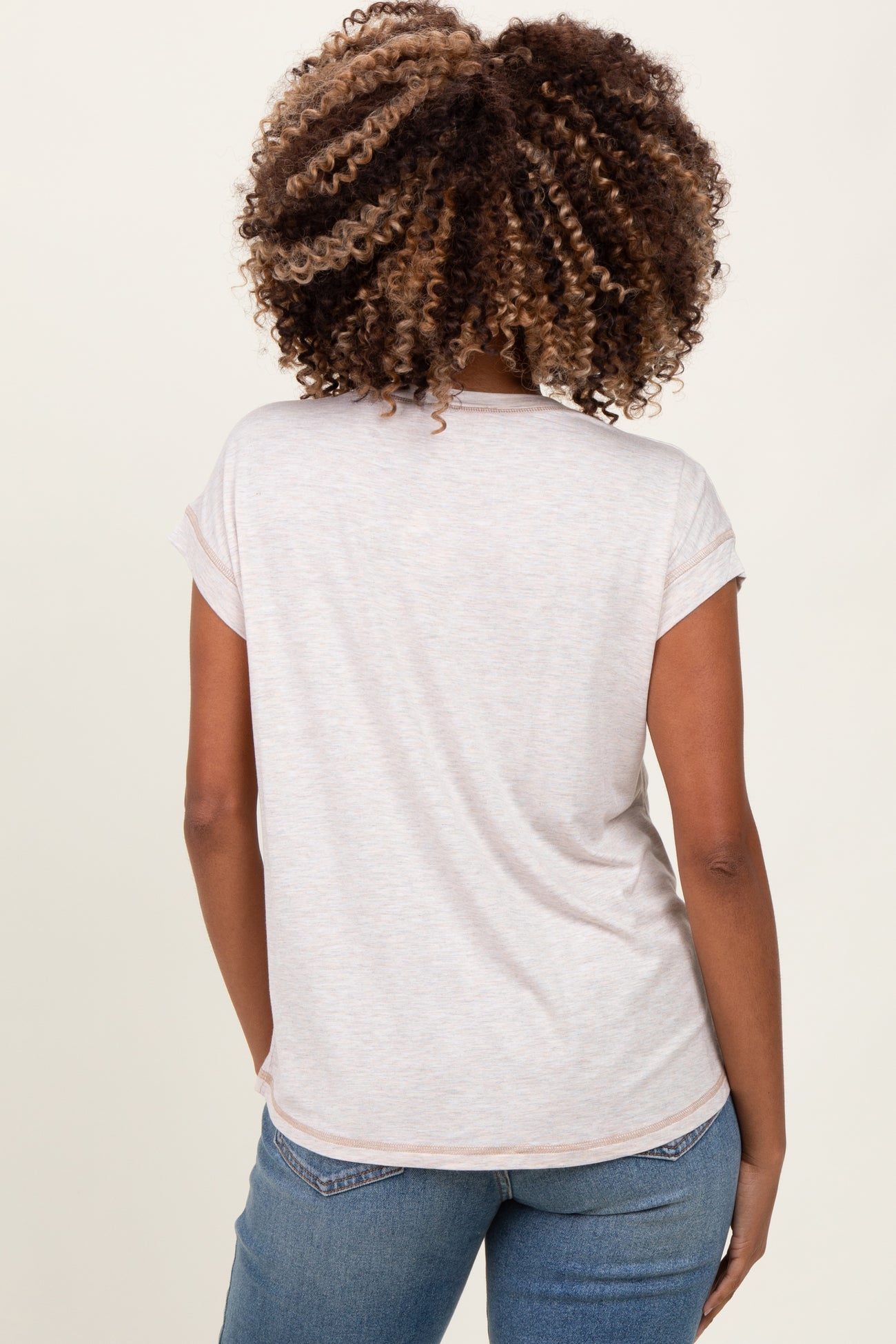 woman wearing a light gray maternity t-shirt with rolled sleeves, viewed from the back