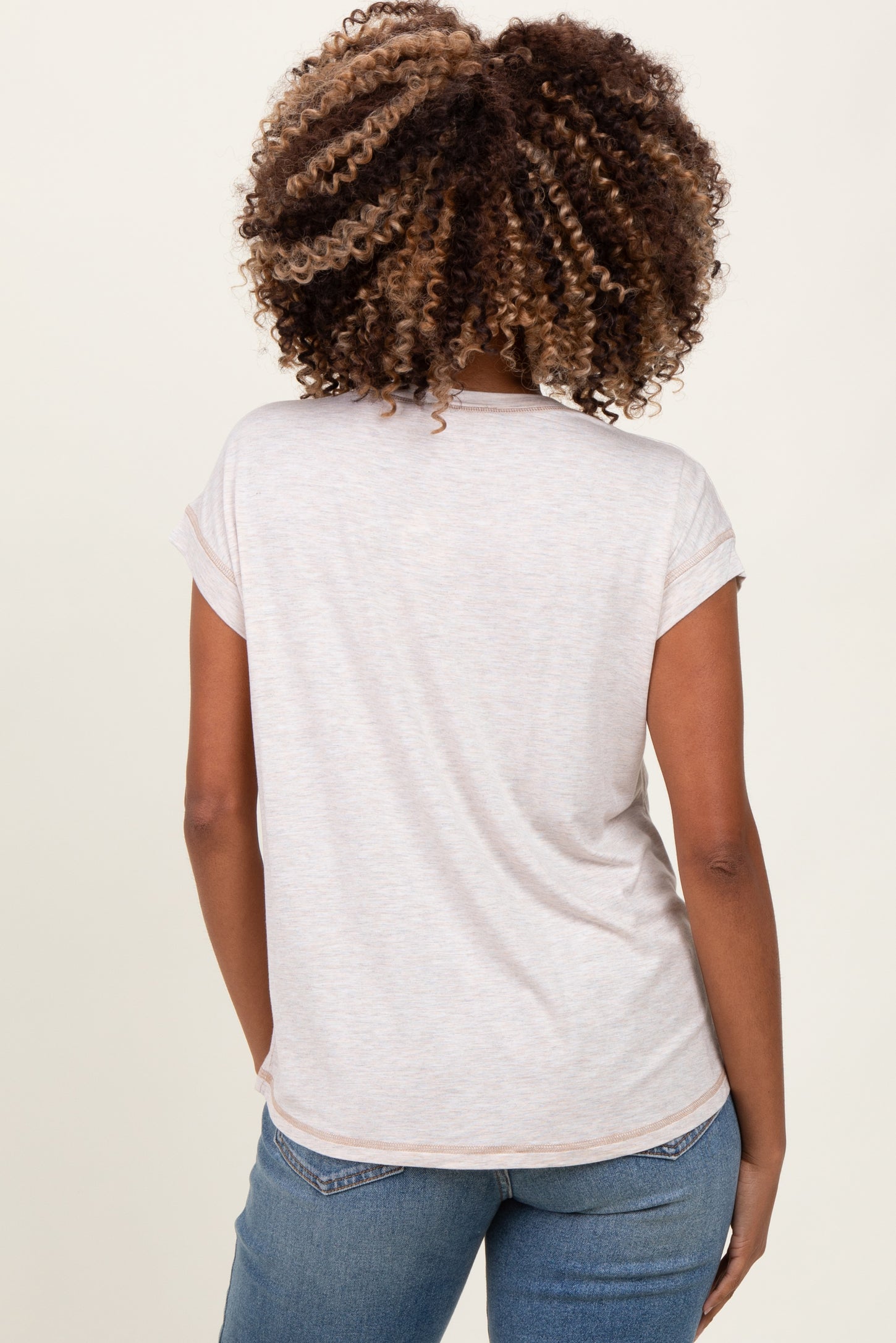 woman wearing a light gray maternity t-shirt with rolled sleeves, viewed from the back