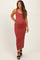 woman wearing a rust colored fitted maternity maxi dress with a visible baby bump