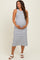 woman wearing a navy and white striped maternity maxi dress and holding her baby bump