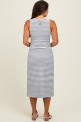 woman wearing a navy and white patterned maternity dress with a keyhole back detail