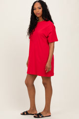woman wearing a red oversized t-shirt dress and black slide sandals