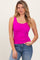 woman wearing a bright pink sleeveless tank top with a scoop neckline and casual blue jeans