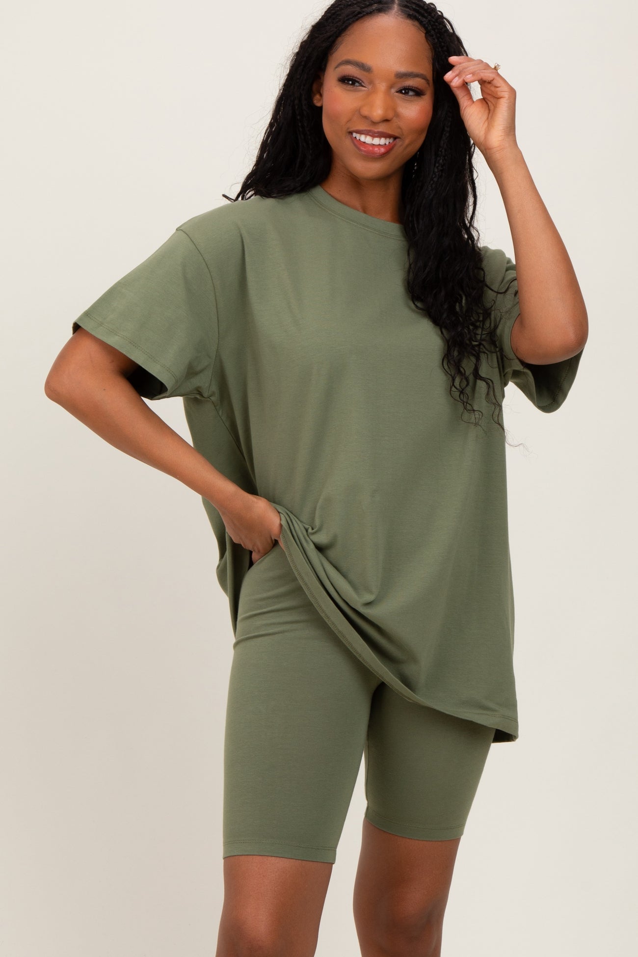 woman wearing an olive green oversized t-shirt and matching bike shorts with a relaxed fit