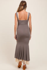woman wearing a gray maternity dress with a fitted silhouette and flared skirt viewed from the back