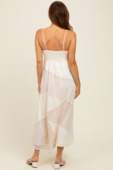 woman wearing a back view of a white maxi dress with a patchwork design and adjustable spaghetti straps