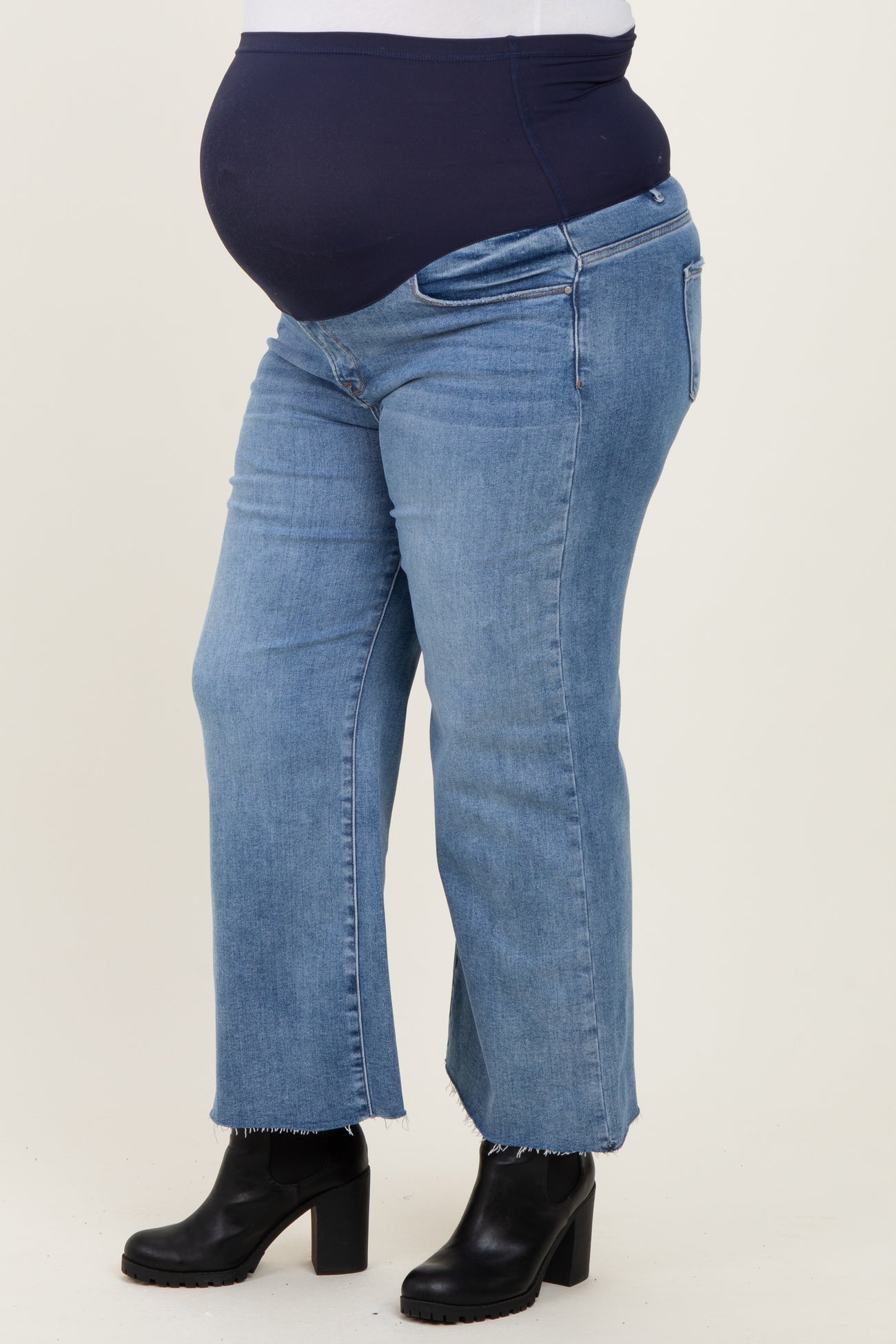 maternity plus size high-waisted blue straight leg jeans with a baby bump visible
