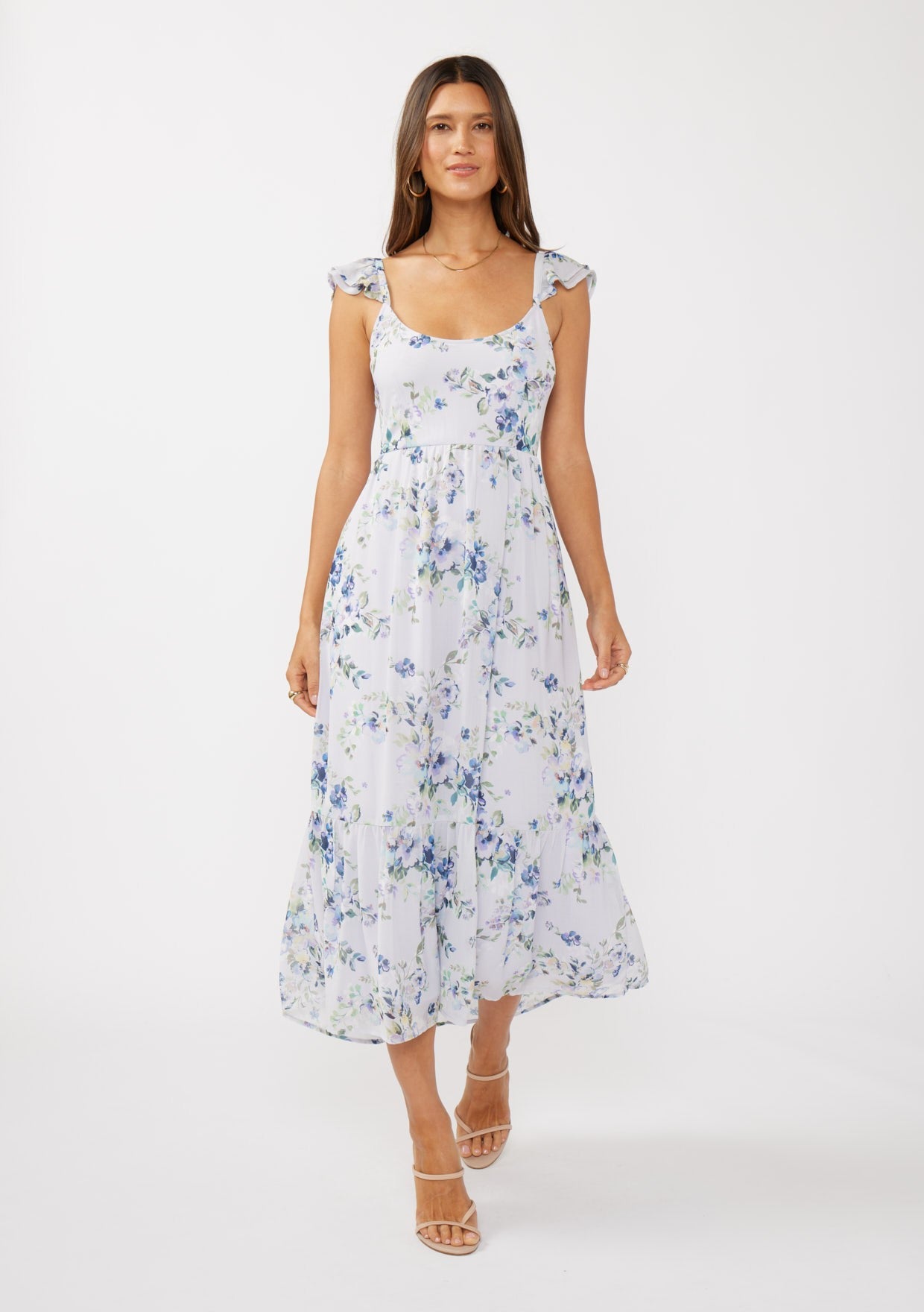 woman wearing a white floral maxi dress with cap sleeves and a fitted bodice