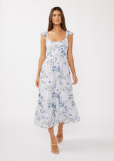 woman wearing a white floral maxi dress with cap sleeves and a fitted bodice